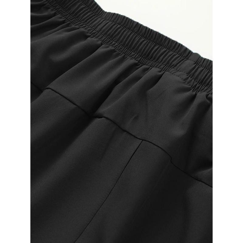 Close-up of black pants with an elastic waistband on a white background